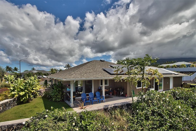 73-4369 Mau Loa Hema Pl, Kailua-Kona, HI 96740 - rear view of house featuring a patio, roof mounted solar panels, and a yard
