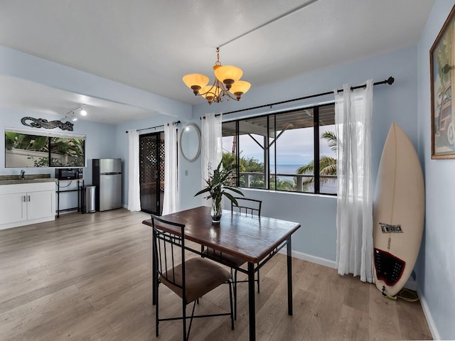 87-3216 Carissa Rd, Captain Cook, HI 96704 - dining space with a chandelier and light wood-style floors