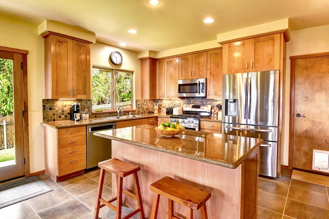 39 Kula Pl Unit 1, Hilo, HI 96720 - kitchen with stainless steel appliances, healthy amount of natural light, recessed lighting, a center island, and stone countertops