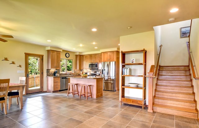 39 Kula Pl Unit 1, Hilo, HI 96720 - kitchen with appliances with stainless steel finishes, a kitchen island, backsplash, recessed lighting, and ceiling fan