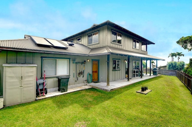 39 Kula Pl Unit 1, Hilo, HI 96720 - back of house featuring board and batten siding, roof mounted solar panels, and a metal roof