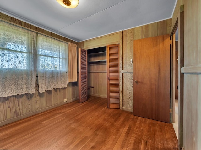 196 Iwalani St, Hilo, HI 96720 - unfurnished bedroom with wood finished floors, a closet, and wooden walls
