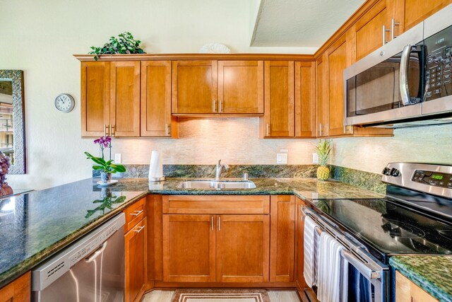 1901 Poipu Rd Unit 824, Koloa, HI 96756 - kitchen with stainless steel appliances, brown cabinetry, and dark stone counters