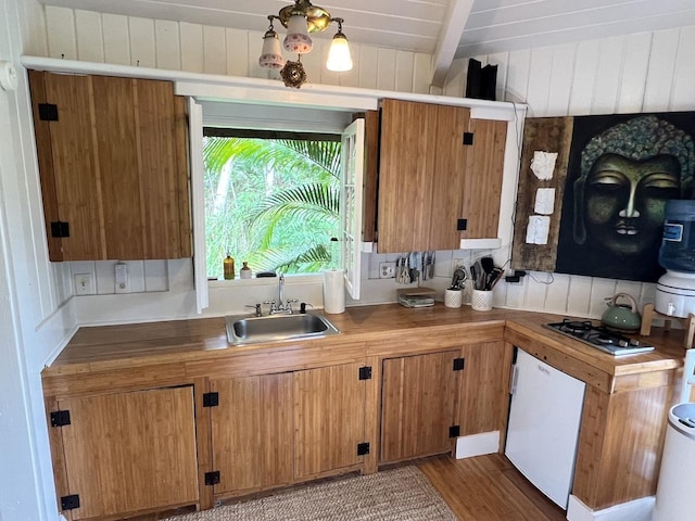 15-1884 9th Ave, Keaau, HI 96749 - kitchen featuring wood finished floors, gas stovetop, beamed ceiling, and brown cabinetry
