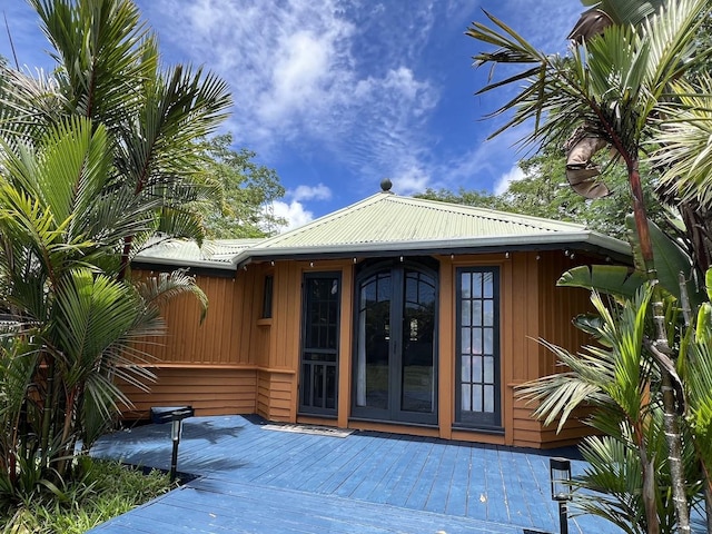 15-1884 9th Ave, Keaau, HI 96749 - doorway to property featuring a wooden deck and a metal roof