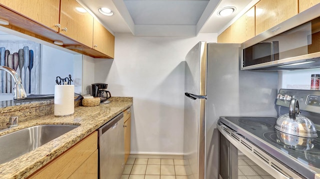 2253 Poipu Rd Unit 218, Koloa, HI 96756 - kitchen with appliances with stainless steel finishes, light tile patterned floors, light stone counters, and light brown cabinets