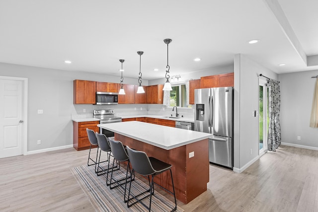 15-1730 29th Ave, Keaau, HI 96749 - kitchen with appliances with stainless steel finishes, light wood-style flooring, a breakfast bar area, recessed lighting, and a kitchen island