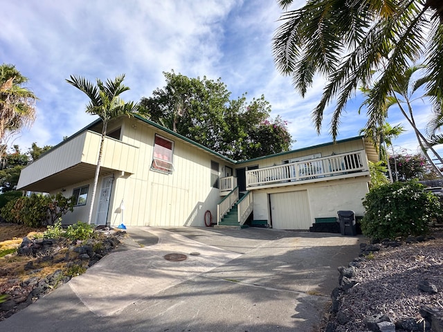 76-6303 Haku Pl, Kailua-Kona, HI 96740 - view of front of home with stairway, concrete driveway, and a balcony