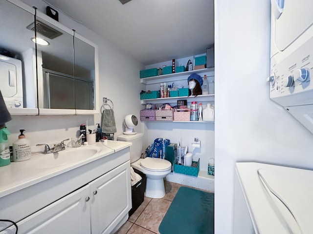 76-6303 Haku Pl, Kailua-Kona, HI 96740 - bathroom with stacked washing machine and dryer, vanity, tile patterned floors, and a shower with shower door