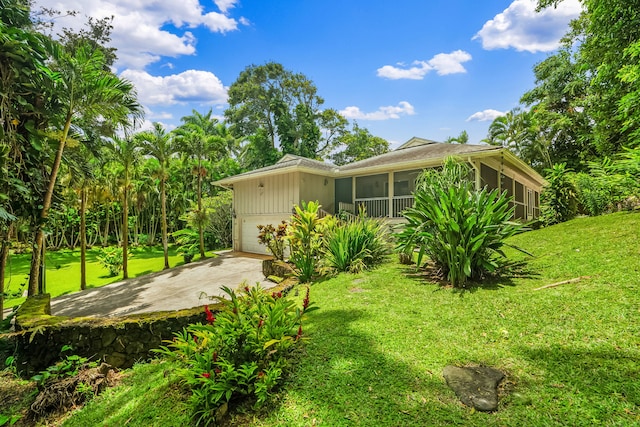 2895 Wawae Rd, Kalaheo, HI 96741 - view of side of home featuring a sunroom, driveway, a lawn, and board and batten siding