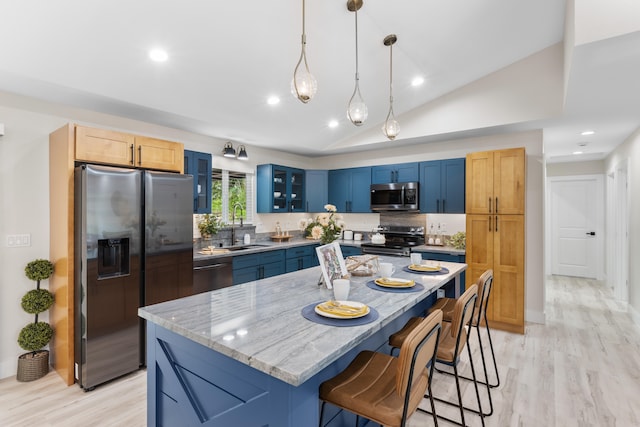 15-1408 13th Ave, Keaau, HI 96749 - kitchen featuring appliances with stainless steel finishes, blue cabinetry, a breakfast bar area, light wood finished floors, and lofted ceiling