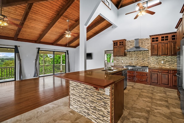 4460 Kai Ikena Dr, Kalaheo, HI 96741 - kitchen with ceiling fan, a wooden ceiling with exposed beams, wall chimney exhaust hood, dark countertops, and open floor plan