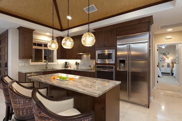 68-1122 Kaniku Dr Unit 426, Kamuela, HI 96743 - kitchen with built in appliances, tasteful backsplash, recessed lighting, a kitchen island, and dark brown cabinets
