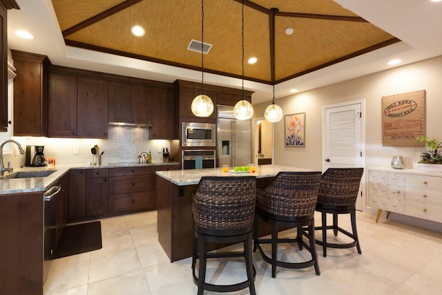 68-1122 Kaniku Dr Unit 426, Kamuela, HI 96743 - kitchen with a raised ceiling, stainless steel appliances, wood ceiling, dark brown cabinets, and a center island