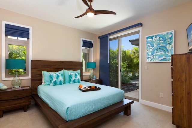 68-1122 Kaniku Dr Unit 426, Kamuela, HI 96743 - bedroom with access to outside, multiple windows, light colored carpet, and ceiling fan