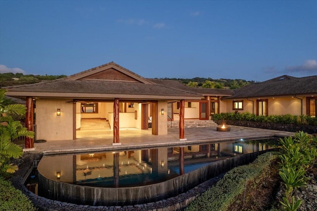 81-580 Kaiue St, Kealakekua, HI 96750 - rear view of house with a patio, an outdoor pool, and stucco siding
