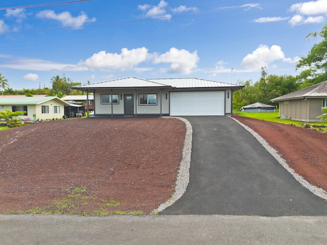 16-2102 Leilani Dr, Pahoa, HI 96778 - ranch-style home featuring asphalt driveway, a metal roof, and an attached garage