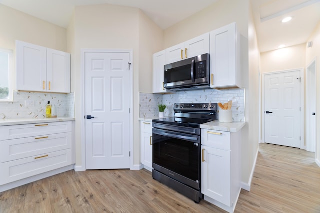 16-2102 Leilani Dr, Pahoa, HI 96778 - kitchen featuring stainless steel microwave, electric range, light wood-type flooring, light countertops, and tasteful backsplash