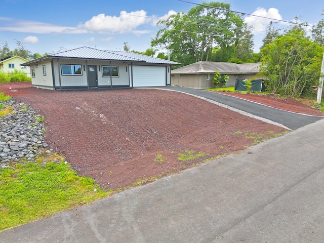 16-2102 Leilani Dr, Pahoa, HI 96778 - ranch-style house featuring driveway, a metal roof, and a garage