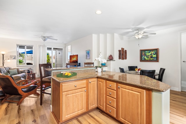 75-5919 Alii Dr Unit M3, Kailua-Kona, HI 96740 - kitchen featuring open floor plan, a ceiling fan, light wood-type flooring, light stone countertops, and recessed lighting