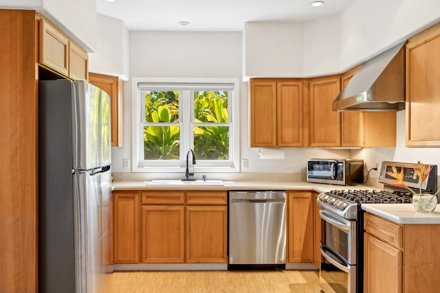 2645 Keoki Pl, Kalaheo, HI 96741 - kitchen featuring appliances with stainless steel finishes, wall chimney range hood, light countertops, and light wood-style flooring