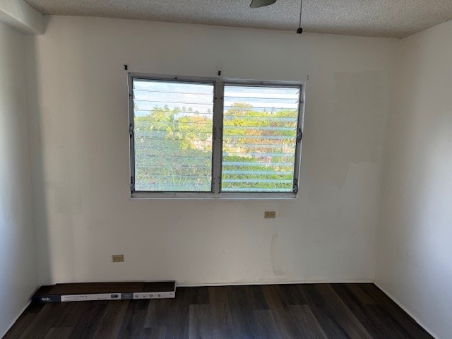75-5766 Kuakini Hwy Unit 210, Kailua-Kona, HI 96740 - unfurnished room featuring plenty of natural light, dark wood-type flooring, a ceiling fan, and a textured ceiling