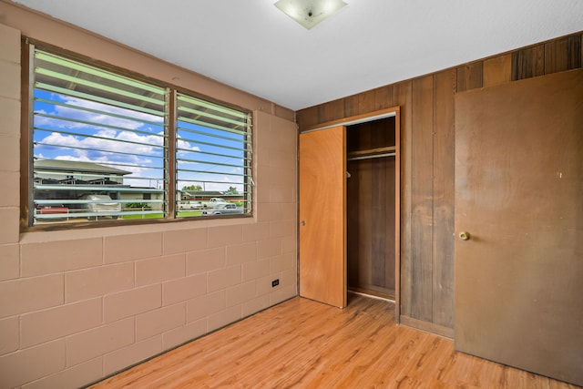 3878 Mamaki St, Koloa, HI 96756 - unfurnished bedroom featuring light wood-type flooring, a closet, and wood walls