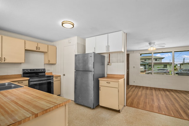3878 Mamaki St, Koloa, HI 96756 - kitchen with freestanding refrigerator, black range with electric stovetop, light floors, a ceiling fan, and cream cabinetry
