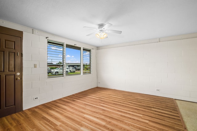 3878 Mamaki St, Koloa, HI 96756 - spare room featuring ceiling fan, concrete block wall, and wood finished floors