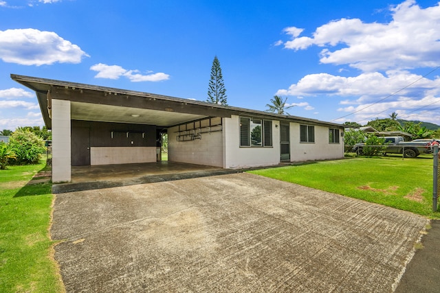 3878 Mamaki St, Koloa, HI 96756 - rear view of property featuring a yard, concrete driveway, and an attached carport