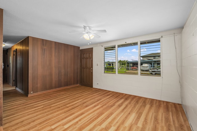 3878 Mamaki St, Koloa, HI 96756 - empty room with ceiling fan, light wood-type flooring, concrete block wall, and wooden walls