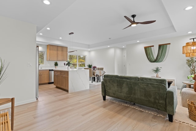 16-2072 Kuhio Dr, Pahoa, HI 96778 - living room with a raised ceiling, recessed lighting, a ceiling fan, and light wood-style flooring