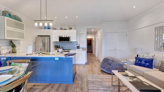 2253 Poipu Rd Unit 216, Koloa, HI 96756 - kitchen with stainless steel appliances, white cabinetry, a peninsula, light wood finished floors, and light countertops