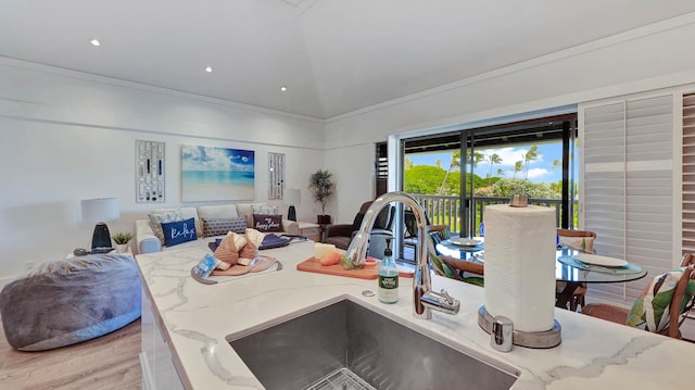 2253 Poipu Rd Unit 216, Koloa, HI 96756 - kitchen with light stone countertops, vaulted ceiling, light wood-style flooring, open floor plan, and recessed lighting
