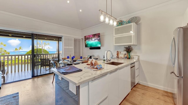 2253 Poipu Rd Unit 216, Koloa, HI 96756 - kitchen with stainless steel appliances, a peninsula, light wood-style flooring, white cabinets, and high vaulted ceiling