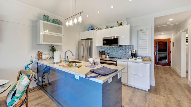 2253 Poipu Rd Unit 216, Koloa, HI 96756 - kitchen with stainless steel appliances, modern cabinets, light wood finished floors, white cabinetry, and recessed lighting