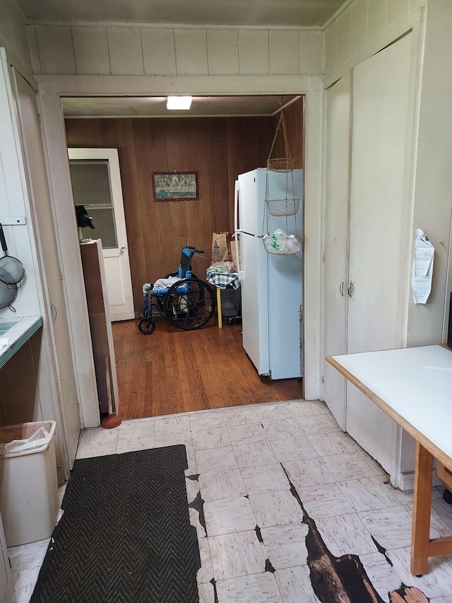 17-4136 Kukui Camp Rd, Mountain View, HI 96771 - kitchen featuring freestanding refrigerator, light flooring, and wooden walls