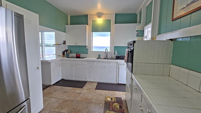 82-6047 Puuhonua Rd, Captain Cook, HI 96704 - kitchen with freestanding refrigerator, tile counters, healthy amount of natural light, and white cabinets