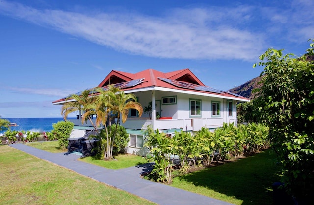82-6047 Puuhonua Rd, Captain Cook, HI 96704 - bungalow-style house featuring solar panels, a front yard, a water view, and stucco siding