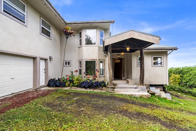 79-1145 Kao Rd, Holualoa, HI 96725 - view of exterior entry featuring stucco siding and a garage