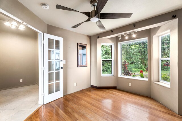 79-1145 Kao Rd, Holualoa, HI 96725 - spare room with plenty of natural light, rail lighting, ceiling fan, and light wood-style floors