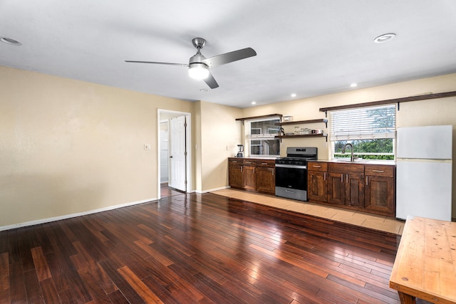 79-1145 Kao Rd, Holualoa, HI 96725 - kitchen featuring freestanding refrigerator, stainless steel gas range, light wood-style flooring, open shelves, and a ceiling fan