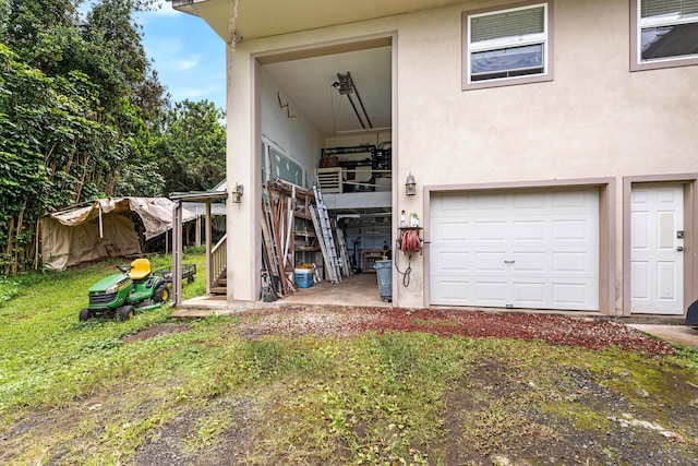 79-1145 Kao Rd, Holualoa, HI 96725 - back of house with stairs, stucco siding, and an attached garage