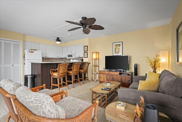 75-6016 Alii Dr Unit 323, Kailua-Kona, HI 96740 - living area with ceiling fan, attic access, and light colored carpet