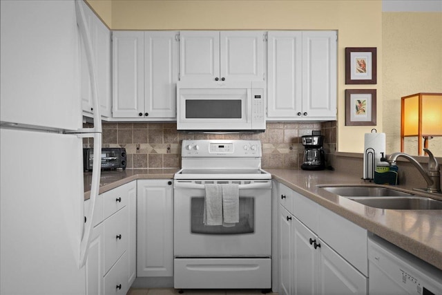 75-6016 Alii Dr Unit 323, Kailua-Kona, HI 96740 - kitchen with white appliances, white cabinetry, and backsplash