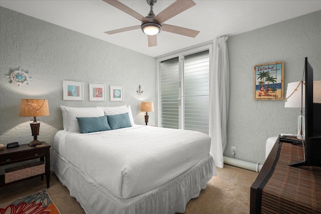 75-6016 Alii Dr Unit 323, Kailua-Kona, HI 96740 - bedroom with a textured wall, light colored carpet, and a ceiling fan