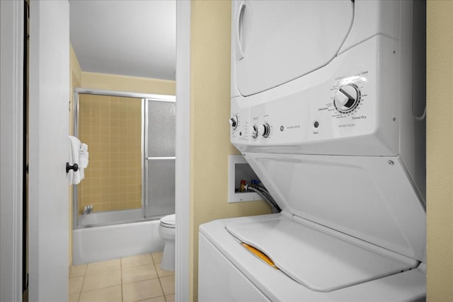 75-6016 Alii Dr Unit 323, Kailua-Kona, HI 96740 - laundry area with estacked washer and dryer and light tile patterned floors