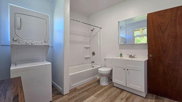 48-5241 Kukuihaele Rd, Honokaa, HI 96727 - bathroom with stacked washer / dryer, wood finished floors, vanity, and tub / shower combination