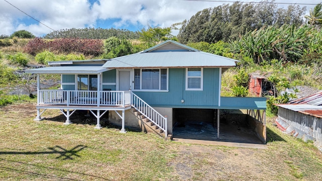 48-5241 Kukuihaele Rd, Honokaa, HI 96727 - view of front of property with driveway, a front lawn, a metal roof, and a porch