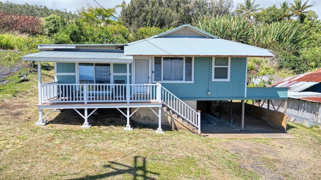 48-5241 Kukuihaele Rd, Honokaa, HI 96727 - view of front of property with a metal roof, a front yard, a porch, driveway, and a carport